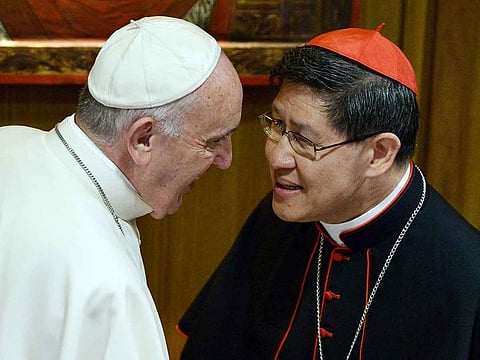 In this file photo taken on October 05, 2015 Pope Francis (left) speaks with Filipino Cardinal Luis Antonio Tagle during a Synod on the family in the Vatican.
