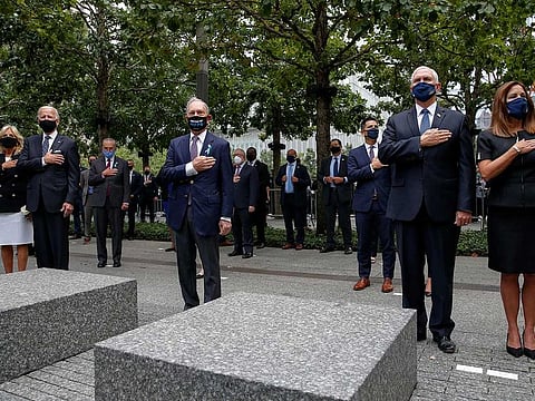 Democratic presidential nominee and former Vice-President Joe Biden and his wife Jill, former New York City Mayor Michael Bloomberg, U.S. Vice-President Mike Pence and his wife Karen all stand with their hands over their hearts as they attend ceremonies marking the 19th anniversary of the September 11, 2001 attacks on the World Trade Center at the 911 Memorial & Museum in New York City, New York, US, September 11, 2020.