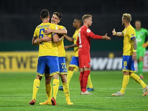 Eintracht Braunschweig's Dominik Wydra and Danilo Wiebe celebrate after beating Hertha Berlin