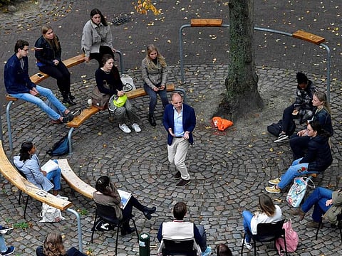 Dutch Professor Edward Nieuwenhuis of Roosevelt College University gives an introduction live science to 25 students outside, on a square in the historic centre of Middelburg, the Netherlands, next to the university on September 8, 2020, because of preventive measures taken against the COVID-19 coronavirus.