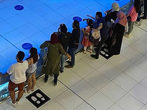 Despite social distancing signs at malls, some residents do not follow the COVID-19 protocol.