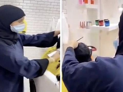 Screenshots from a video, which has gone viral, showing a Saudi female working in a barber shop.