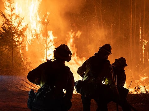 Firefighters monitor a firing operation to contain the Bear fire in Oroville, California, U.S., on Sunday, September 13, 2020.