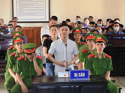 This picture taken on September 14, 2020 shows defendants at a trial against those involved in organising for people to migrate abroad, in connection with the deaths of 39 migrants found in a refrigerated truck in Britain last year, at a court in Ha Tinh province.