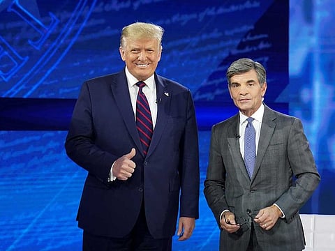 US President Donald Trump takes the stage with ABC News chief anchor George Stephanopoulos for a town hall event in Philadelphia, Pennsylvania, U.S., September 15, 2020.