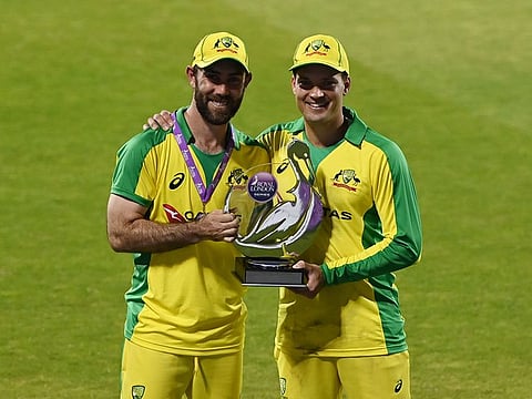 Australia's Glenn Maxwell and Alex Carey pose with the trophy after winning the match and the series.