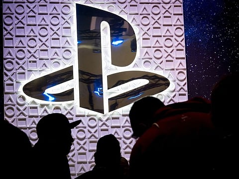 Attendees wait in a line at the Sony PlayStation booth at the Game Developers Conference in San Francisco on March 20, 2019.