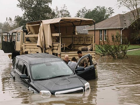 Members of the Florida National Guard rescue local residents Joe Hernandez, 66, and his wife Tammy Hurd, 53, from their flooded vehicle on Bristol Park Road in Cantonment, Fla., Wednesday, Sept. 16, 2020, after the Hurricane Sally slowly moved through the area.