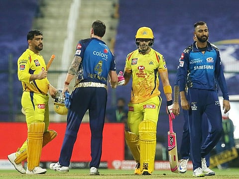 Mumbai Indians and Chennai Super Kings players greet each other after the match.