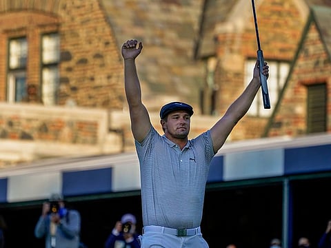 Bryson DeChambeau reacts after sinking a putt for par on the 18th hole to win the US Open Golf Championship, Sunday, Sept. 20, 2020, in Mamaroneck, New York.
