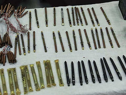 In this handout photograph taken on September 19, 2020 and released by Afghanistan's Ministry of Interior Affairs (MOI), a stash of "pen guns" and sticky bombs are displayed by officials following a police forces operation, in a residential house in Kabul.