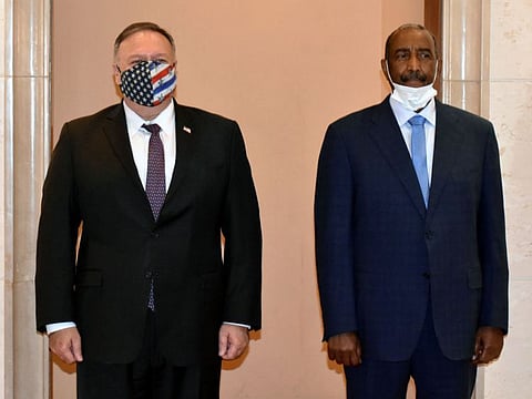 In this file photo US Secretary of State Mike Pompeo (L) poses for a picture with Sudan's Sovereign Council chief General Abdel Fattah Al Burhan in Khartoum on August 25, 2020.