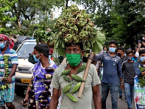 Farmers wearing vegetable garlands attend a protest march against farm bills passed by India's parliament, in Kolkata, India, September 23, 2020.