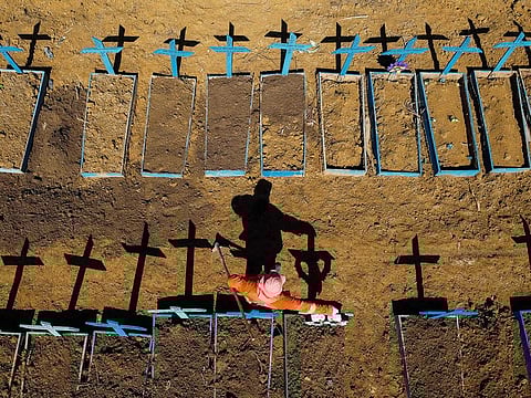 An aerial view of a gravedigger standing at the Nossa Senhora Aparecida cemetery where COVID-19 victims are buried daily, in the neighbourhood of Taruma, in Manaus, Brazil, during the coronavirus pandemic on June 2, 2020.