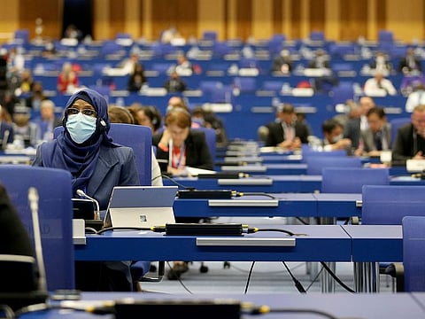 People sit at desks keeping social distance during the general conference of the IAEA, in Vienna, Austria, Monday, Sept. 21, 2020.