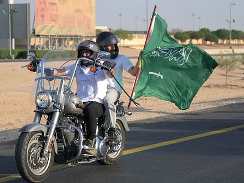 Saudi and expat riders of the Hawks Riyadh MC club wave a national flag as they ride their motorcycles around the capital Riyadh, during a parade to mark the Saudi National Day last year..