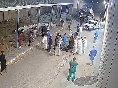 Relatives of a patient, who died from the coronavirus disease (COVID-19), beat up Tarik Sheibani, 47, an Iraqi doctor and director of Al-Amal Hospital, in this still image taken from CCTV footage obtained by Reuters, in Najaf, Iraq August 27, 2020. Picture taken August 27, 2020. Al-Amal Hospita