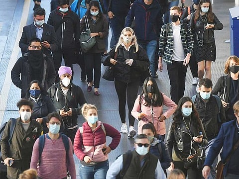 Commuters at Waterloo Station, in London, after Britain's Prime Minister Boris Johnson announced a range of new restrictions to combat the rise in coronavirus cases in England.