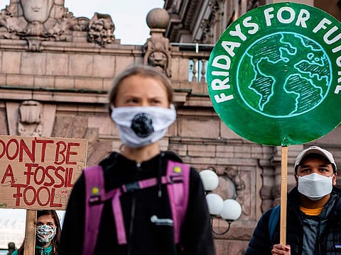 Swedish climate activist Greta Thunberg (C) fronts a Fridays For Future protest at the Swedish Parliament (Riksdagen) in Stockholm on September 25, 2020.