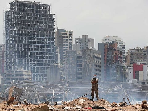 In this Aug. 6, 2020, file photo, a soldier stands at the devastated site of the explosion in the port of Beirut, Lebanon.