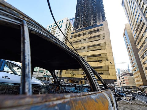 Burnt cars and debris outside the Abbco Tower in Al Nahda, Sharjah, a day after the fire broke out in May.