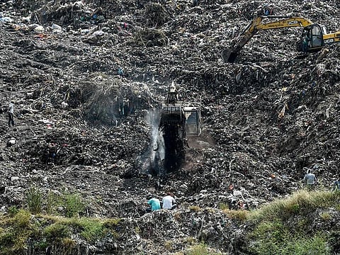 Rescue workers conduct a search operation on the Pirana landfill after Neha Vasava, 12, got buried under a mass of trash that fell while she was collecting discarded toys on the garbage mountain with her friend Anil Marwadi, 6, who got rescued, on the outskirts of Ahmedabad on September 27, 2020.