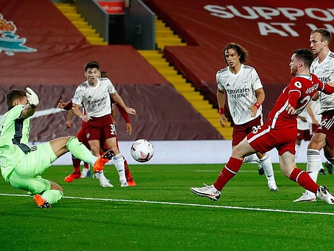 Liverpool's Andrew Robertson (second right) scores his team's second goal against Arsenal during their English Premier League match at Anfield on Monday.