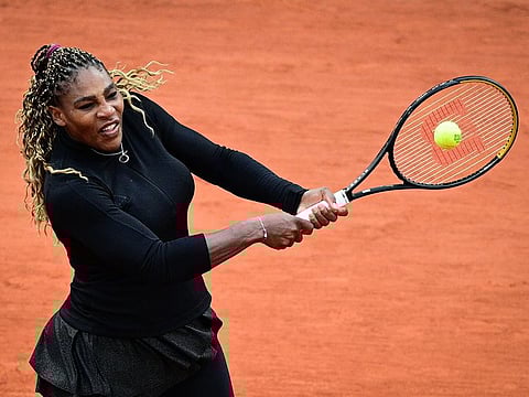 Serena Williams returns the ball to Kristie Ahn during their women's singles first round match.