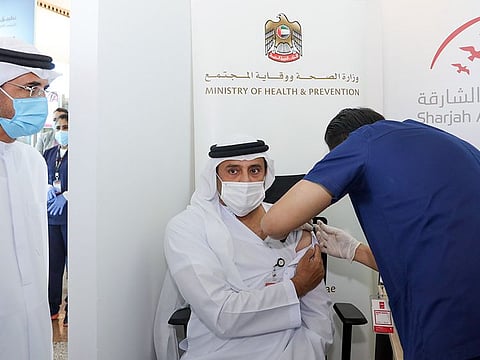Ali Salem Al Midfa, Chairman of Sharjah International Airport Authority, receives the first dose of the Covid-19 vaccine.