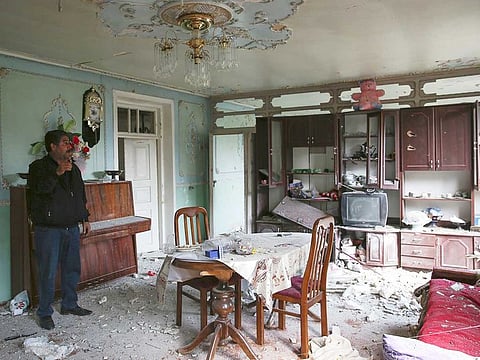 Local resident stands in an apartment building that was allegedly damaged by recent shelling during fighting over the breakaway region of Nagorno-Karabakh in Tartar region, Azerbaijan on September 30, 2020.