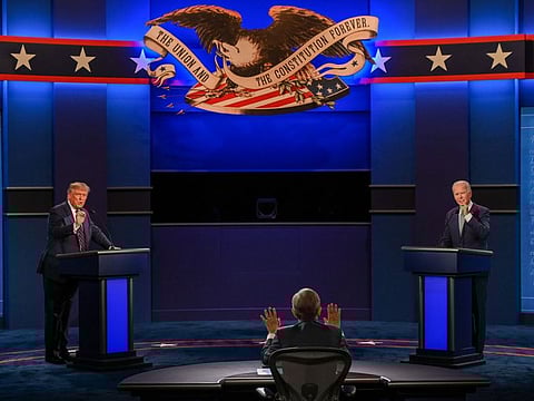 US President Donald Trump and Democratic Presidential candidate  Joe Biden exchange arguments as moderator Chris Wallace (C) raises his hands to stop them during the first presidential debate at Cleveland, Ohio, on September 29, 2020
