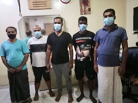 Sharafudheen (centre), an Indian expat from Kuwait, along with four of his colleagues staying in a shared accommodation for bachelors in Dubai say they can’t afford the ticket fare for their onward journey.
