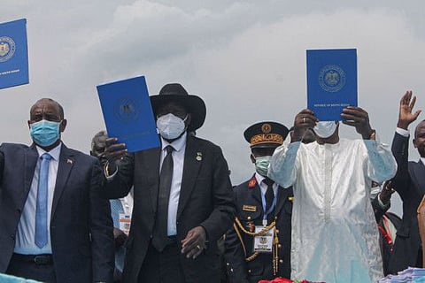 Chairman of Sudan's Sovereign Council Abdel Fattah Al Burhan (left), South Sudan's President Salva Kiir (centre) and Chadian President Idriss Deby (right) hold a copy of the South Sudan peace deal, signed in Juba on October 3, 2020.