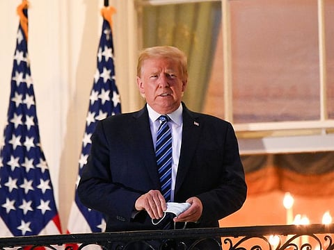 U.S. President Donald Trump poses on the Truman Balcony of the White House after returning from being hospitalized at Walter Reed Medical Center for coronavirus disease (COVID-19) treatment, in Washington, U.S. October 5, 2020.