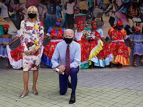 Democratic presidential candidate former Vice President Joe Biden and his wife Jill Biden pose for a photo with dancers as they visit Little Haiti Cultural Complex, Monday, Oct. 5, 2020, in Miami.