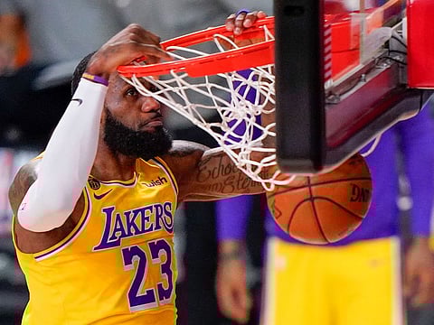 Los Angeles Lakers forward LeBron James dunks against the Miami Heat during the first half in Game 4 of basketball's NBA Finals, in Lake Buena Vista, Florida.