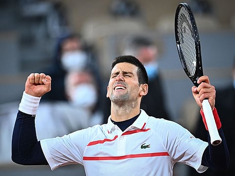 Novak Djokovic celebrates after winning against Pablo Carreno Busta in the French Open quarter-finals in Paris on October 7, 2020.