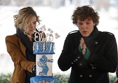 Riley Keough, 21, left, cuts the birthday cake as her brother, Benjamin, 18, right, warms his hands as they take part in a ceremony commemorating Elvis Presley's 75th birthday on Friday, Jan. 8, 2010 in Memphis, Tenn. Both are the children of Lisa Marie Presley and the grandchildren of Elvis Presley.