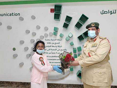 Dubai Police honours student who distributed flowers to frontliners.