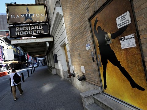A man walks past the shuttered Richard Rodgers Theatre, home of the popular musical "Hamilton" in New York, U.S., July 2, 2020.