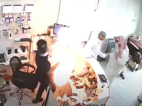 The moment the phone explodes in the technician's face in the shop in Saudi Arabia.