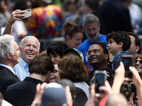 Former US Vice-President Joe Biden takes a selfie with Indian American supporters during a rally in Philadelphia