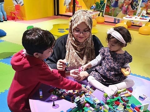 Play time for Samihah Zaman with her children. She says it is difficult for her moving on from a place where she feel at home.