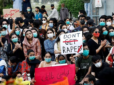 People carry signs against a gang rape that occurred along a highway and to condemn violence against women and girls, during a protest in Karachi, Pakistan September 12, 2020.