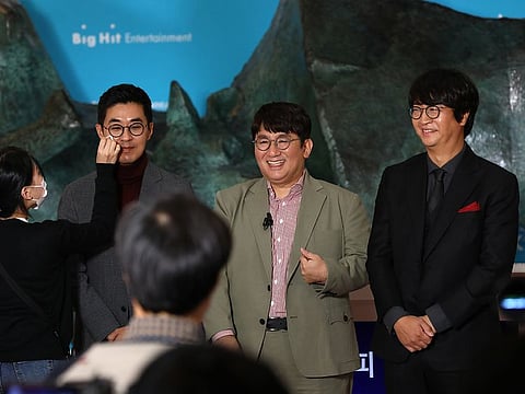 It's all landing on the sweet spot... Bang Si-hyuk, founder of Big Hit Entertainment Co., middle, and other executives attend the company's initial public offering ceremony at the Korea Exchange (KRX) in Seoul, South Korea, on Thursday, Oct. 15, 2020.