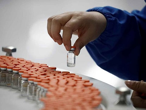 A worker performs a quality check in the packaging facility of Chinese vaccine maker Sinovac Biotech.