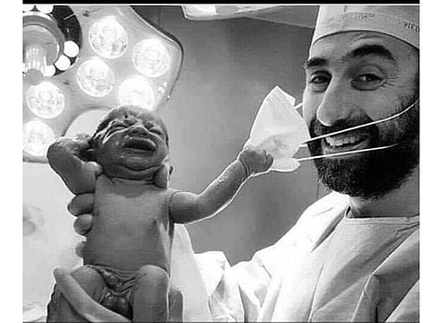 Dr Samer Cheaib with the newborn.