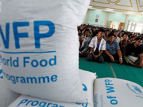 FILE PHOTO: Food rations provided by the World Food Programme (WFP) are pictured in the foreground as Muslims seeking shelter at a monastery listen to a speech by Religious Affairs Minister San Sint at Lashio township May 31, 2013.