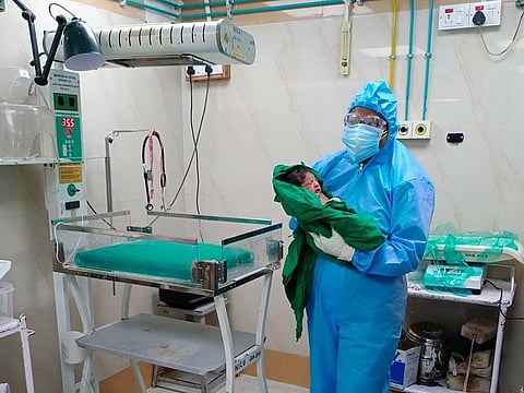 Shayla Srivastava, an obstetrician at BYL Nair Charitable Hospital in Mumbai, holds a baby born to a coronavirus-positive mother on May 31.