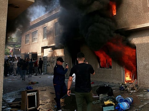 The headquarters of Kurdish Democratic Party burn during a protest by pro-Iranian militiamen and their supporter in Baghdad, Iraq, Saturday, Oct. 17, 2020.